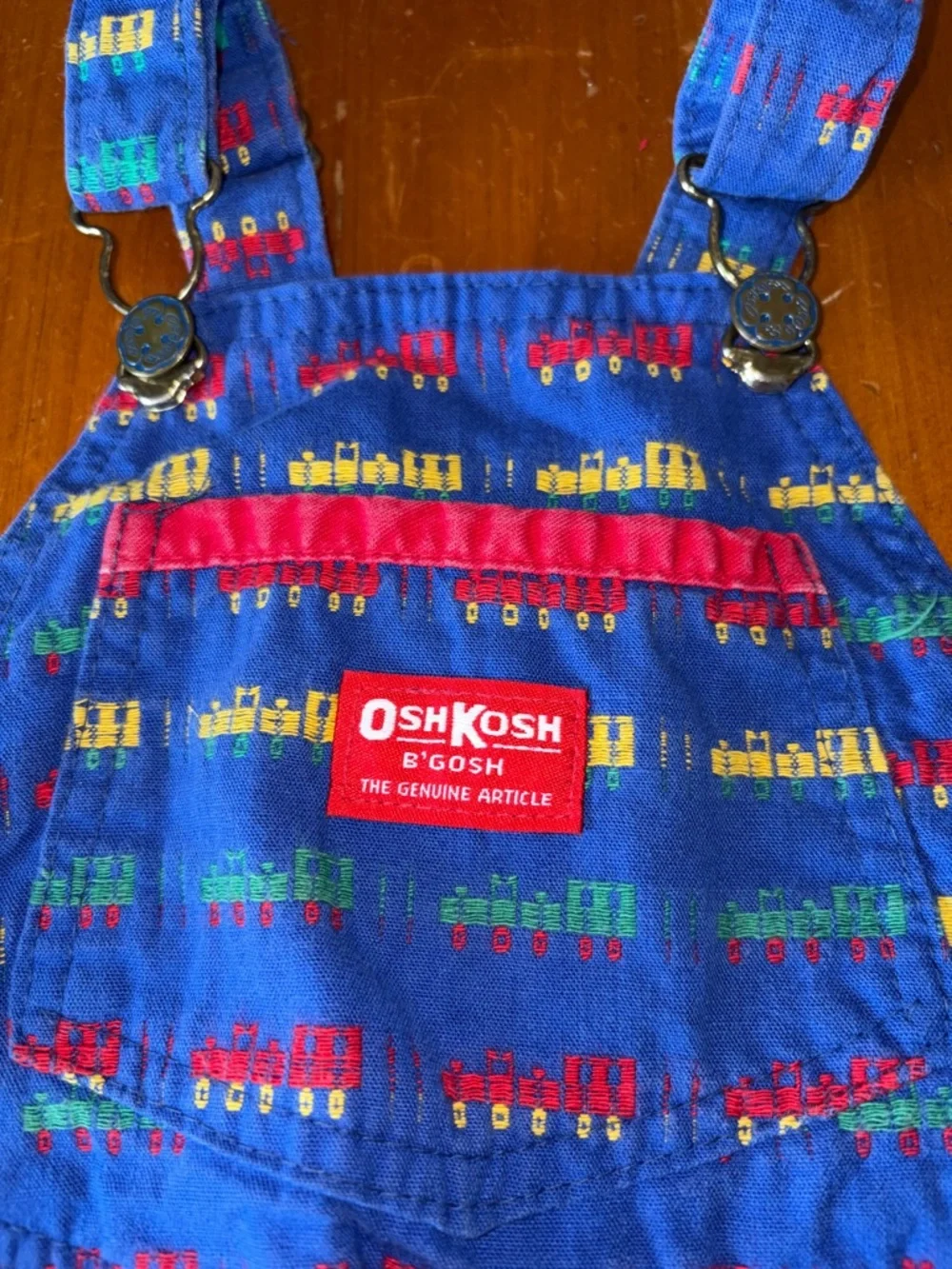 OshKosh B'gosh Bright Blue Overalls with Red, Yellow and Green Train Print